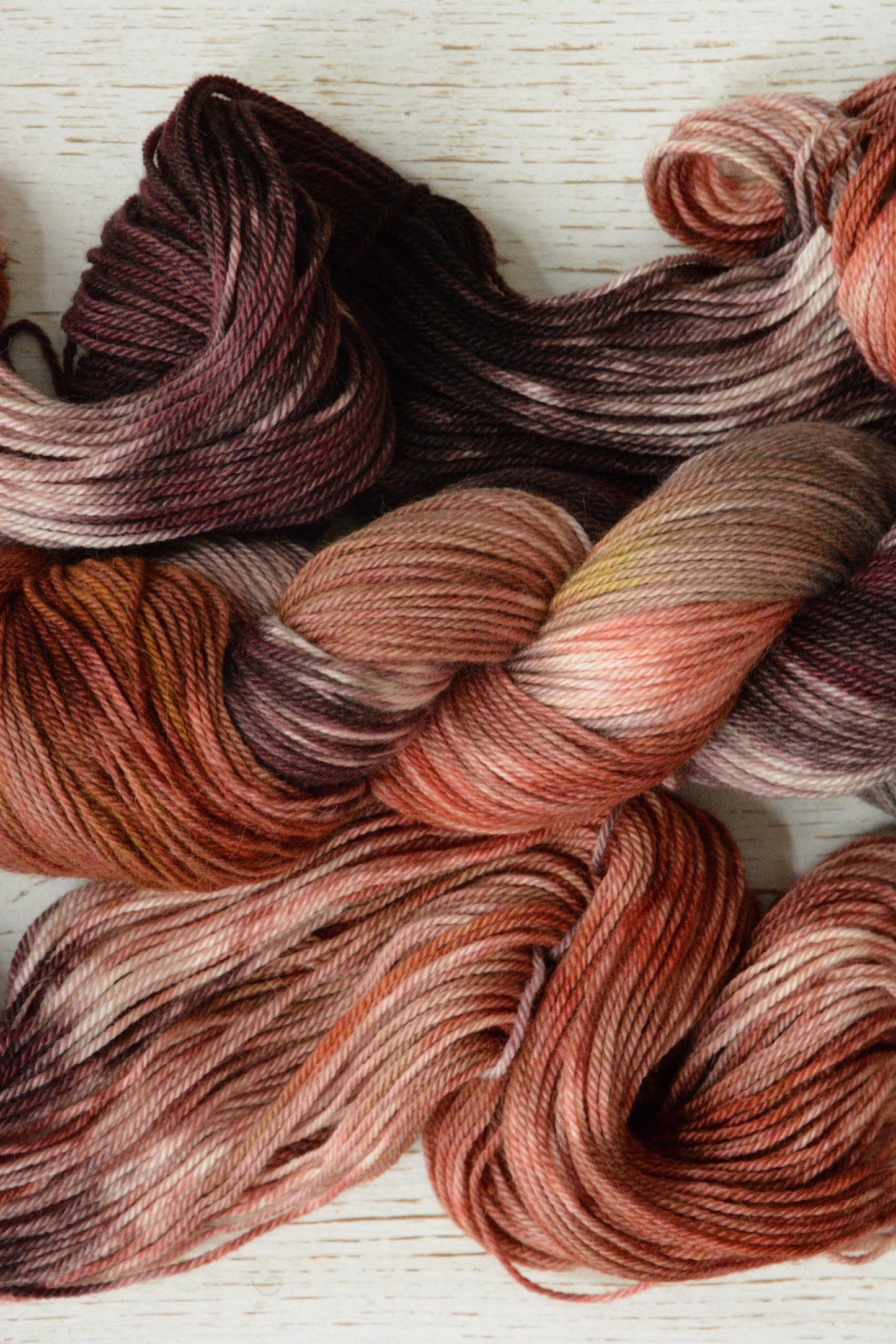 Peach Stone - alpaca merino blend on soft sport weight yarn, non-super wash, 100g 328 yds, warm peach pink, tan gold, gray brown variegated.