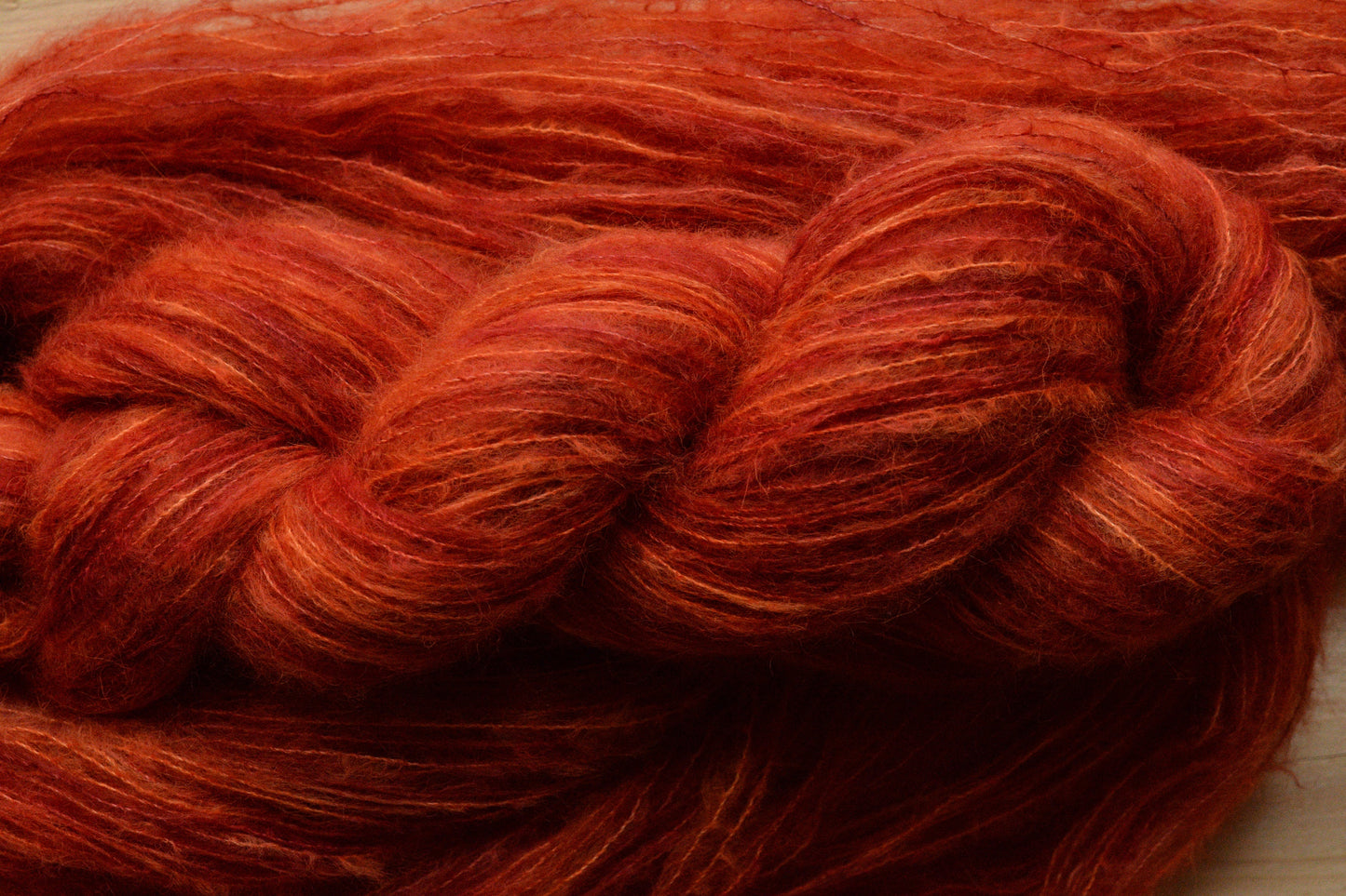 Blood Orange - brushed lace weight 74 per cent baby suri alpaca 26 per cent silk, 50g 328 yards, orange red. Silk core. Soft, extra fluffy.