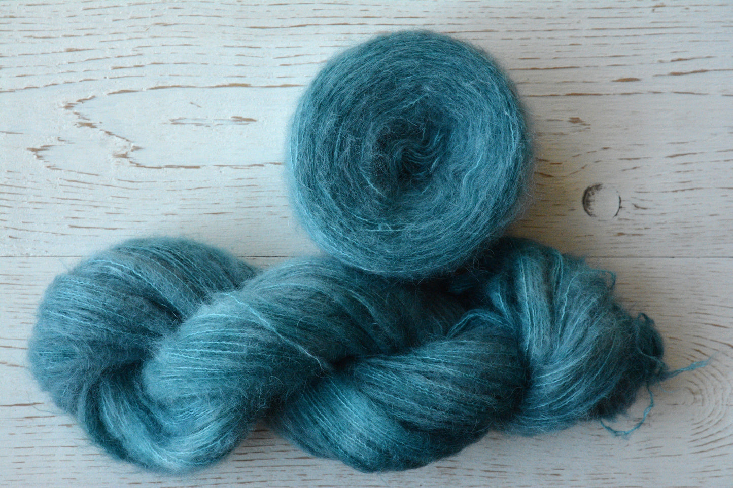 Siren - brushed lace weight 74 per cent baby suri alpaca 26 per cent silk, 50g 328 yards. Silk core. Soft extra fluffy. Aqua, turquoise.