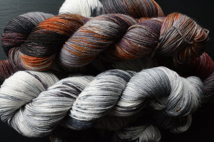 The Drive - alpaca merino blend 3 ply non-super wash sport weight yarn. 100g 328 yards, gray, burgundy wine, orange, black. Super soft yarn.