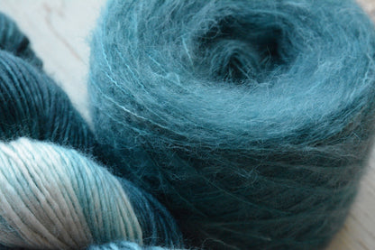 Siren - brushed lace weight 74 per cent baby suri alpaca 26 per cent silk, 50g 328 yards. Silk core. Soft extra fluffy. Aqua, turquoise.