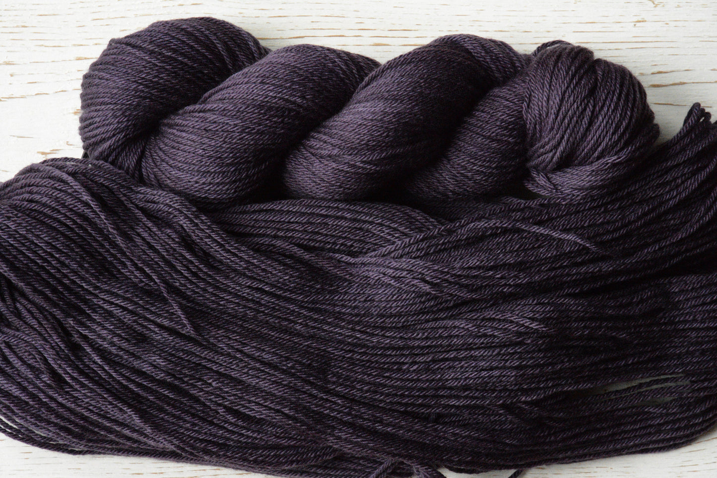 Damson - 4-ply 100% non-super wash worsted weight merino yarn. 100g, 218 yards, deep plum purple. Soft 20.5 micron. Semi-solid.