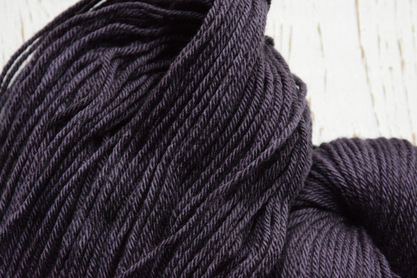 Damson - 4-ply 100% non-super wash worsted weight merino yarn. 100g, 218 yards, deep plum purple. Soft 20.5 micron. Semi-solid.