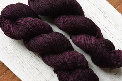 Mulberry - 4-ply 100% non-super wash worsted weight merino yarn. 100g, 218 yards, deep reddish purple. Soft 20.5 micron. Semi-solid.