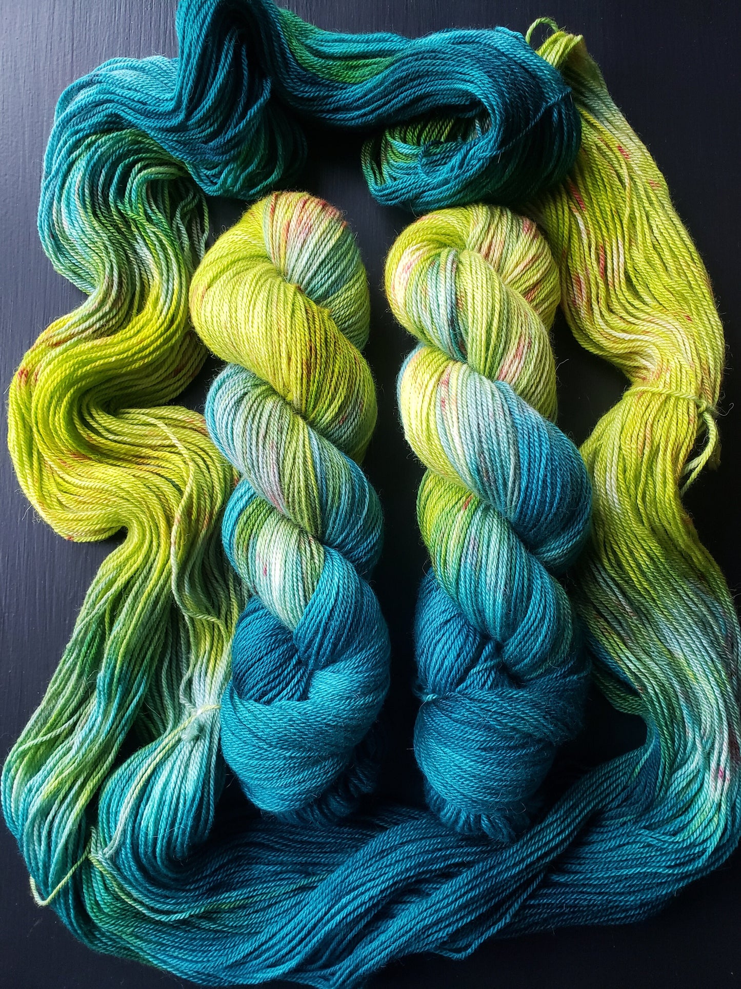 Serendipity - alpaca merino blend, sport weight yarn, non-super wash, 100g 328 yds, teal green chartreuse with orange speckles, super soft.