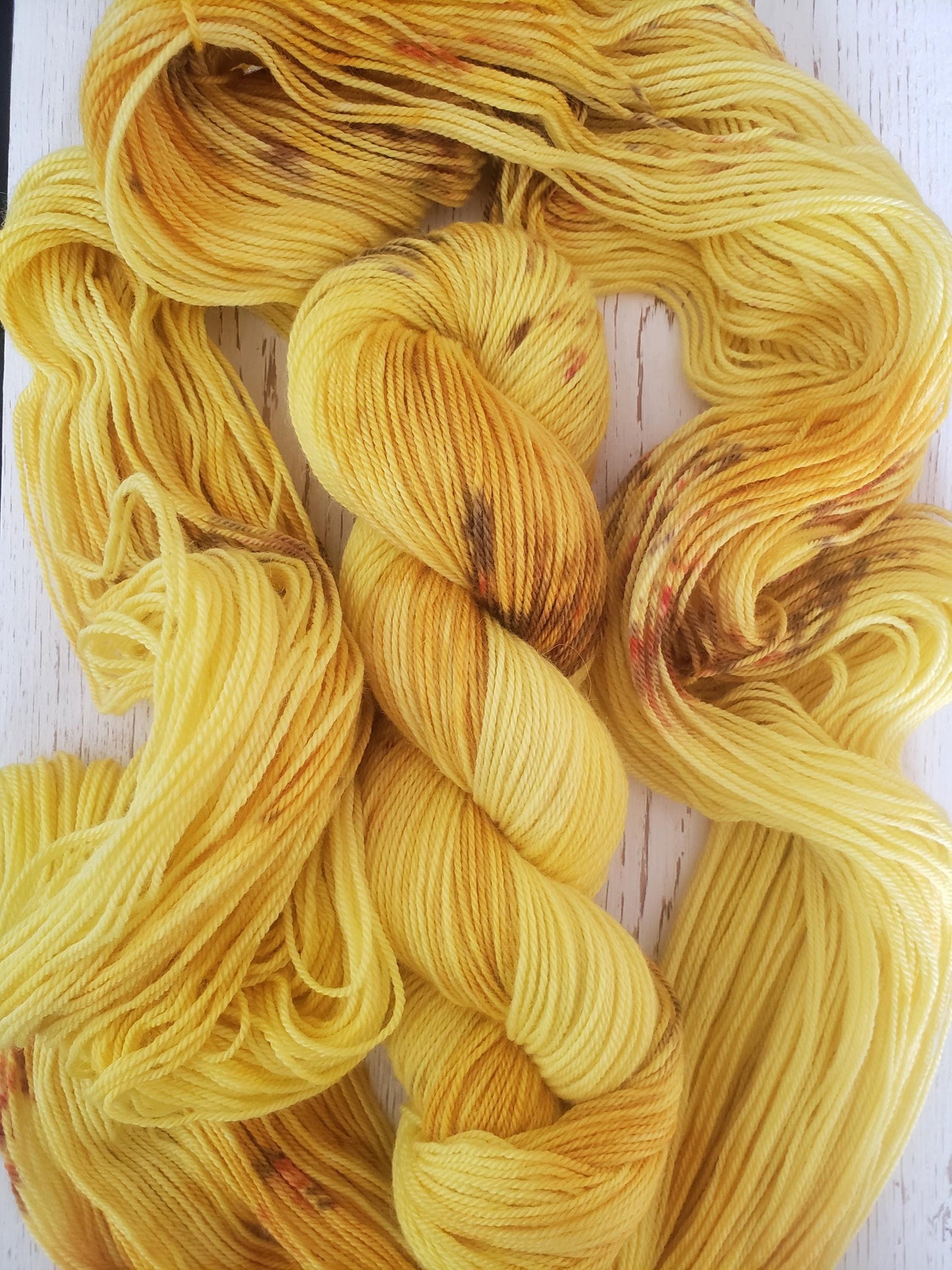 Sunflower - alpaca merino blend, sport weight yarn, non-super wash, 100g 328 yds, sunny yellow with brown and orange speckles, super soft.