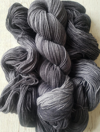 Shadows - alpaca merino blend 3 ply non-super wash sport weight yarn. 100g, 328 yards, tonal charcoal gray.