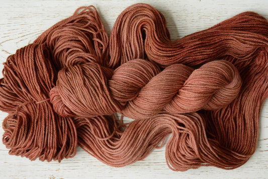 Pink Clay - 4-ply 100% non-super wash worsted weight merino yarn. 100g, 218 yards, dusky peach pink clay tones. Soft 20.5 micron.